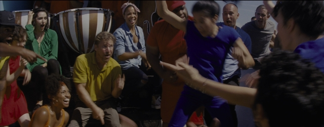 Wide shot frame from La La Land — sitting, standing, room