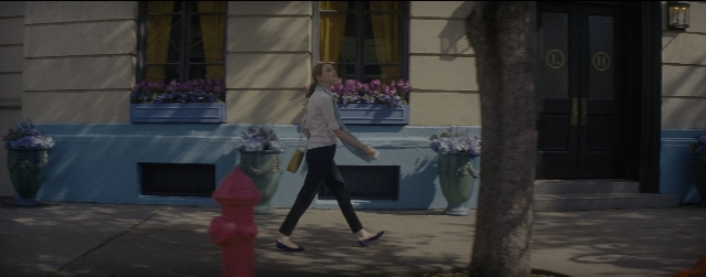 Wide shot frame from La La Land — walking, door, street
