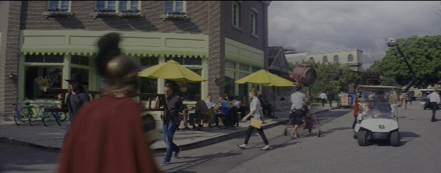 Wide shot frame from La La Land — sitting, walking, street