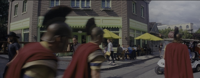 Wide shot frame from La La Land — sitting, walking, dialogue