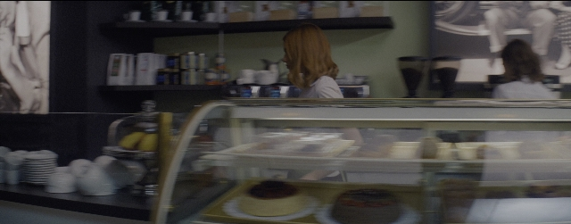 Wide shot frame from La La Land — standing, plate, bottle