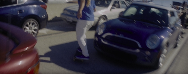 Wide shot frame from La La Land — walking, car, shirt
