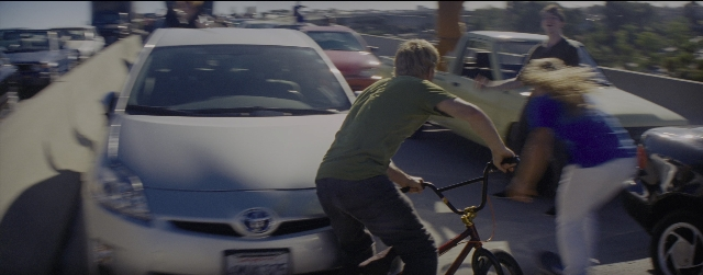 Wide shot frame from La La Land — standing, dialogue, street
