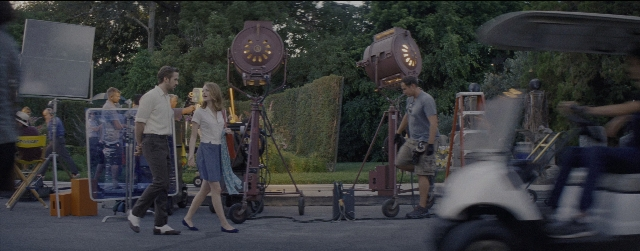 Wide shot frame from La La Land — sitting, walking, dialogue