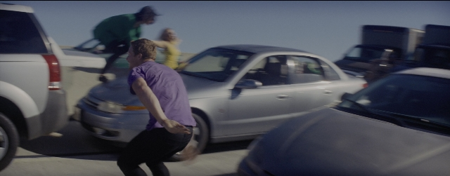 Frame from La La Land — standing, hat, car