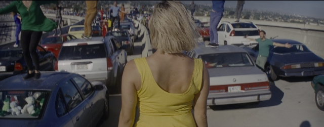 Wide shot frame from La La Land — standing, walking, street