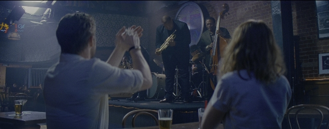 Wide shot frame from La La Land — sitting, table, glass