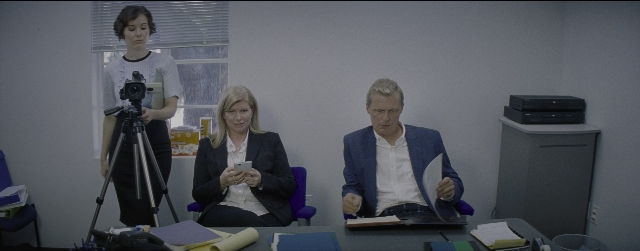Wide shot frame from La La Land — sitting, phone, hand