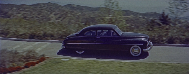 Wide shot frame from La La Land — street, car, wheel