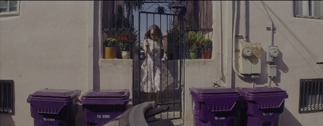 Wide shot frame from La La Land — standing, house, dress
