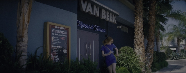 Wide shot frame from La La Land — standing, hand, dress