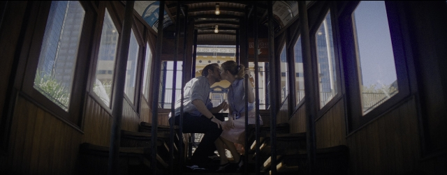 Wide shot frame from La La Land — sitting, kiss, car