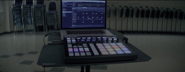 Wide shot frame from La La Land — sitting, laptop, computer keyboard
