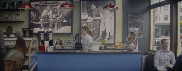 Wide shot frame from La La Land — sitting, street, person