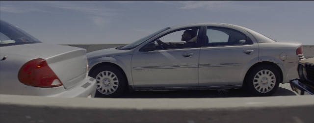 Wide shot frame from La La Land — street, car, shirt