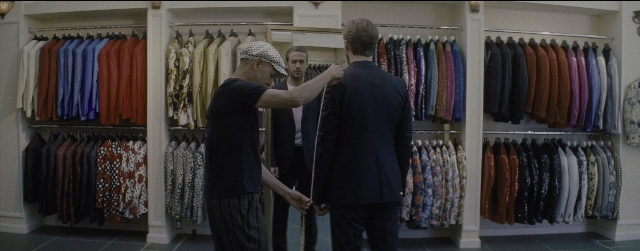 Wide shot frame from La La Land — standing, hand, suit