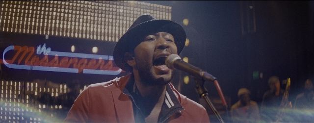 Wide shot frame from La La Land — hat, microphone, person