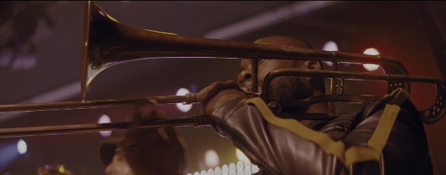 Frame from La La Land — trombone, person, human face