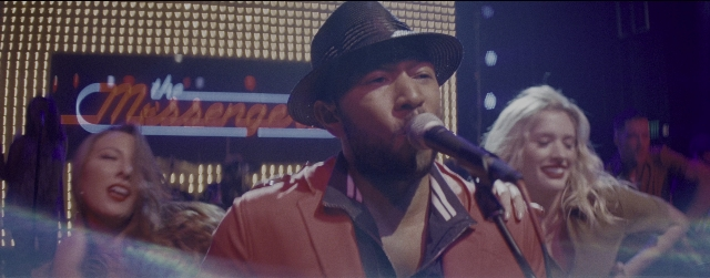 Wide shot frame from La La Land — hat, microphone, beard