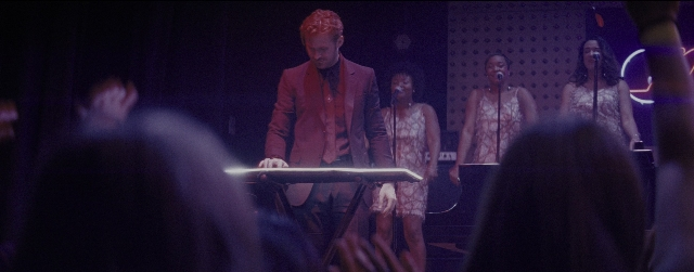 Wide shot frame from La La Land — suit, face, person