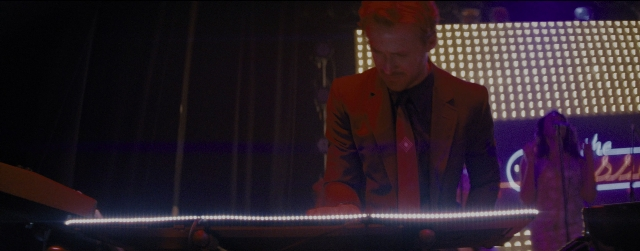 Wide shot frame from La La Land — standing, suit, tie