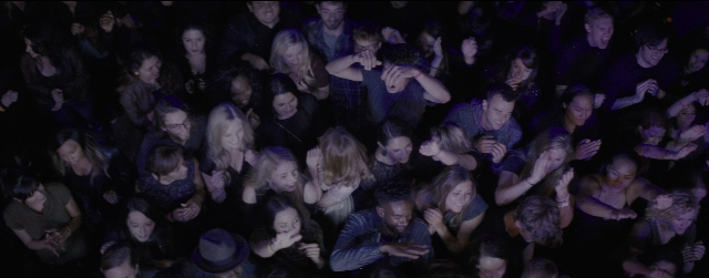Wide shot frame from La La Land — standing, room, person