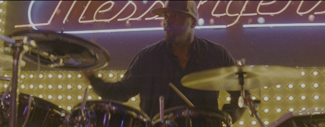 Wide shot frame from La La Land — hat, hand, shirt