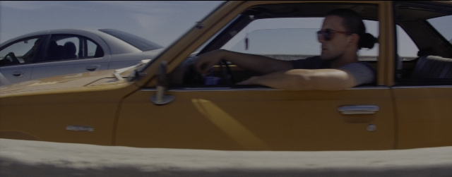 Frame from La La Land — sitting, car, shirt
