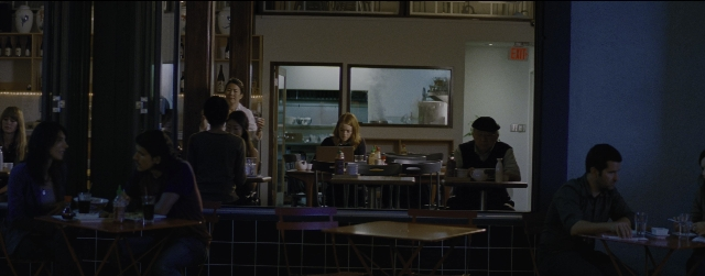 Wide shot frame from La La Land — sitting, table, dialogue