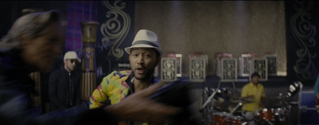 Wide shot frame from La La Land — standing, room, hat