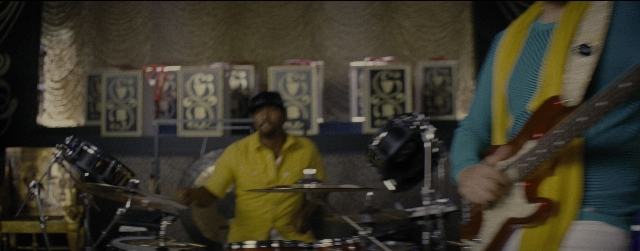 Wide shot frame from La La Land — room, hat, hand