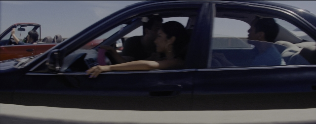Frame from La La Land — sitting, standing, street