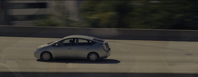 Wide shot frame from La La Land — street, car, wheel