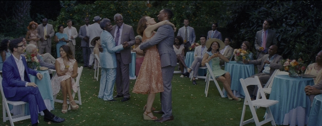 Medium shot frame from La La Land — sitting, standing, kiss