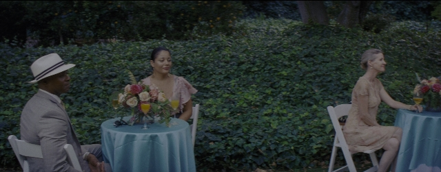 Wide shot frame from La La Land — sitting, table, dialogue