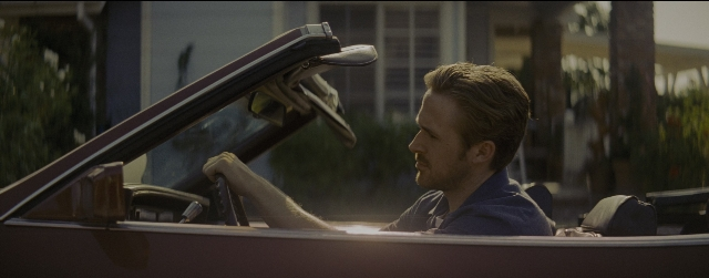 Wide shot frame from La La Land — sitting, car, shirt
