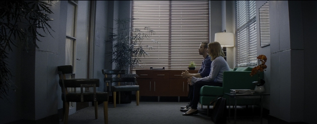 Wide shot frame from La La Land — sitting, room, table