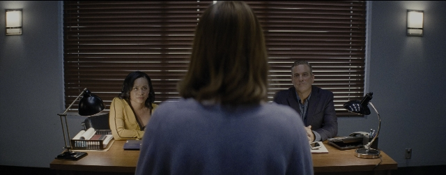 Wide shot frame from La La Land — sitting, desk, phone