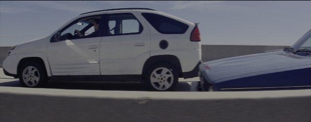 Wide shot frame from La La Land — door, street, car