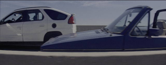 Wide shot frame from La La Land — door, car, wheel