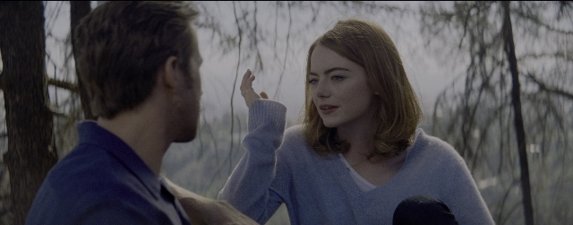 Wide shot frame from La La Land — standing, hand, face