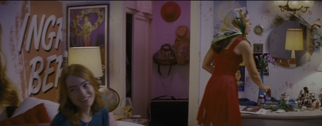 Wide shot frame from La La Land — sitting, standing, room