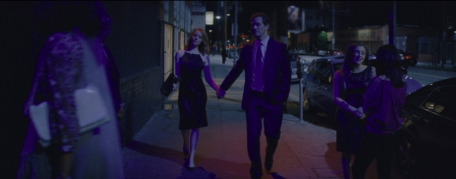 Wide shot frame from La La Land — walking, street, suit