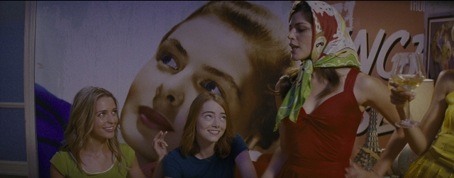 Wide shot frame from La La Land — sitting, room, table