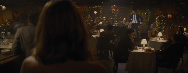 Wide shot frame from La La Land — sitting, standing, room