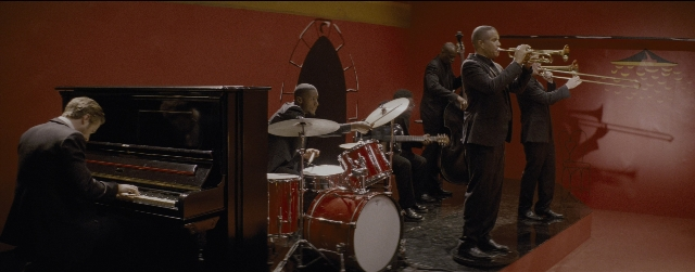 Wide shot frame from La La Land — sitting, standing, trumpet