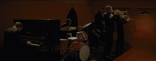 Wide shot frame from La La Land — sitting, standing, room