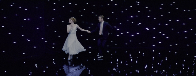 Wide shot frame from La La Land — walking, suit, tie
