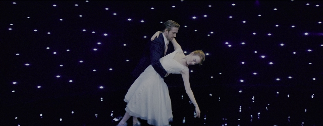 Wide shot frame from La La Land — kiss, suit, dress