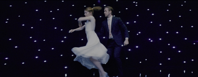 Frame from La La Land — standing, suit, tie